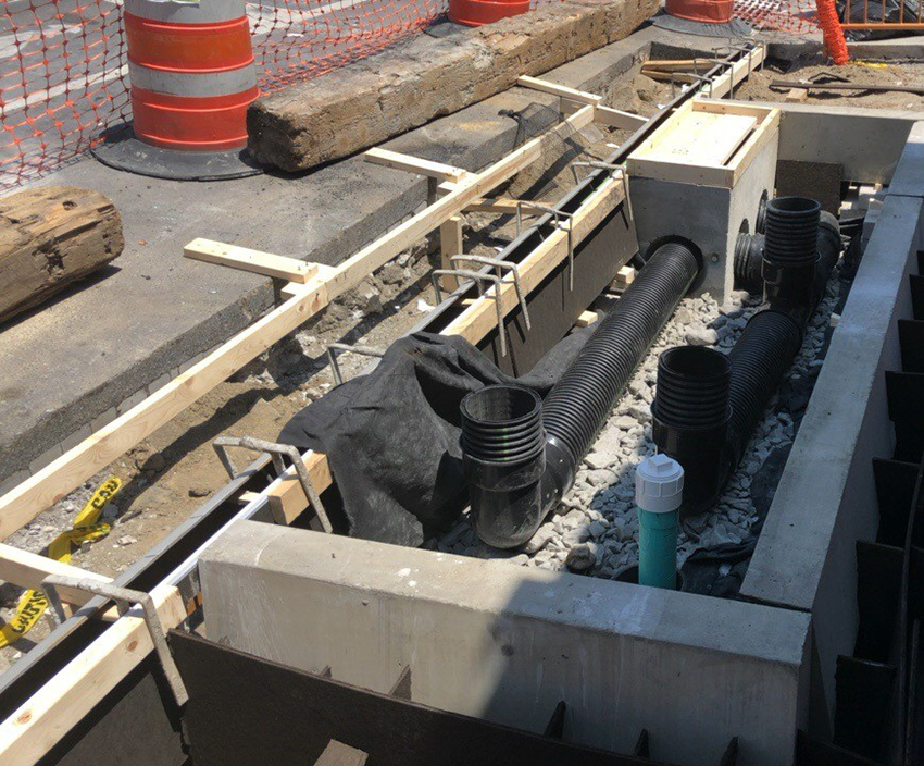 Infiltration basins, like this one being constructed by HRCG, can have foliage or concrete tops — the latter of which is a good replacement option in cases where well-meaning volunteers could potentially weed-wack plants away. (Photograph courtesy of Hunter Roberts Construction Group)