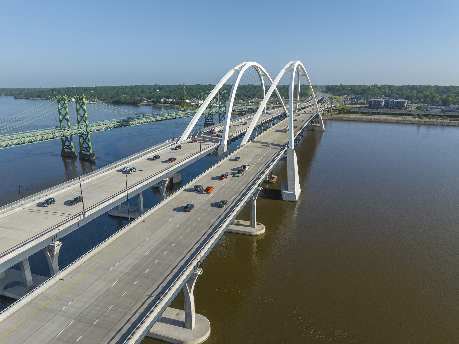 Photos shows an aerial view of the new and existing twin-span bridges. 