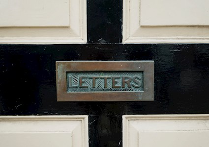 door with a brass opening to insert mail into