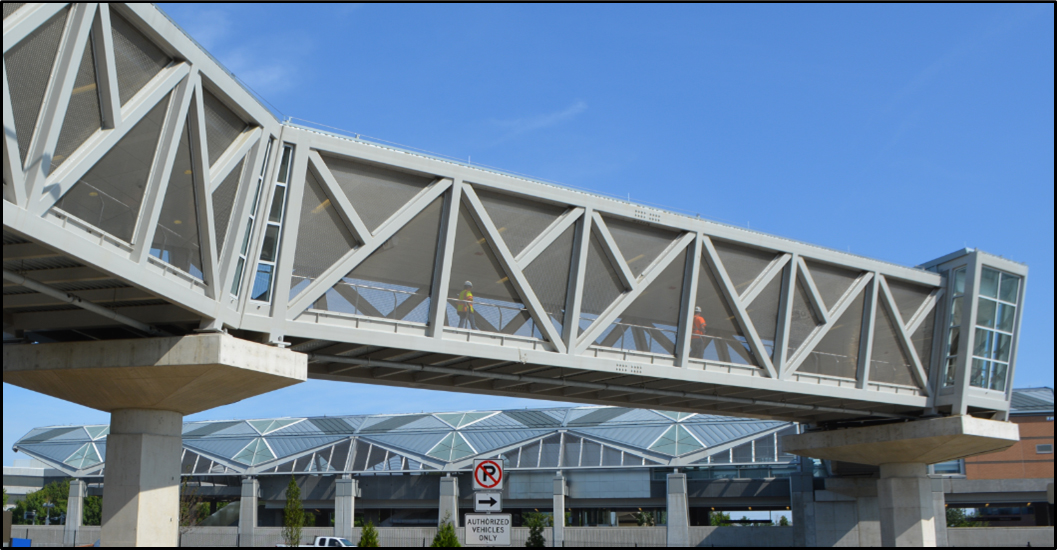 Five of the six new stations were constructed at grade in the median of major highways, necessitating the use of nine pedestrian bridges, including this one at the Herndon Station. (Image courtesy of Dulles Corridor Metrorail Project)
