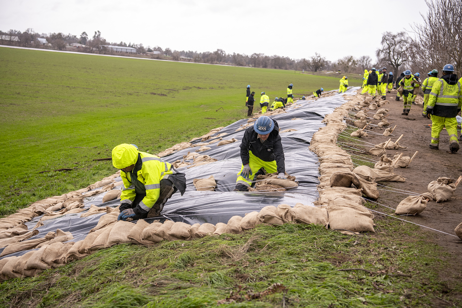 Members of the California Conservation Corps perform emergency repairs to damaged sections of a levee along the Cosumnes River in Wilton, California. (Image courtesy of Kenneth James/California Department of Water Resources)