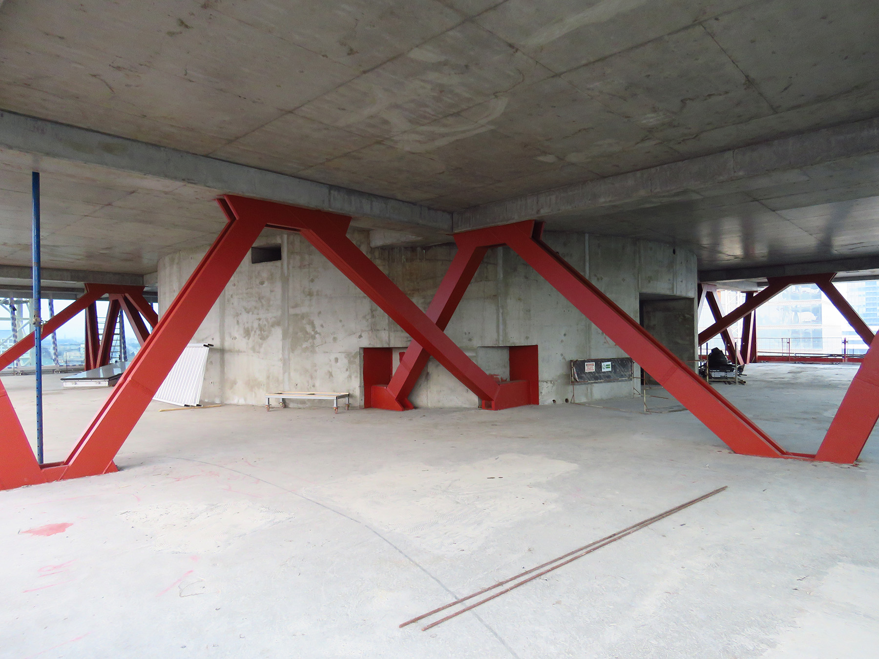 Red angular beams support a structure’s flooring.