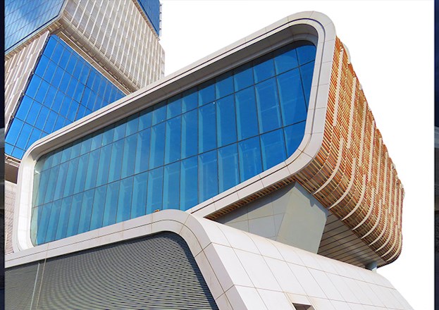 Image shows part of an auditorium with multistory glass windows. 