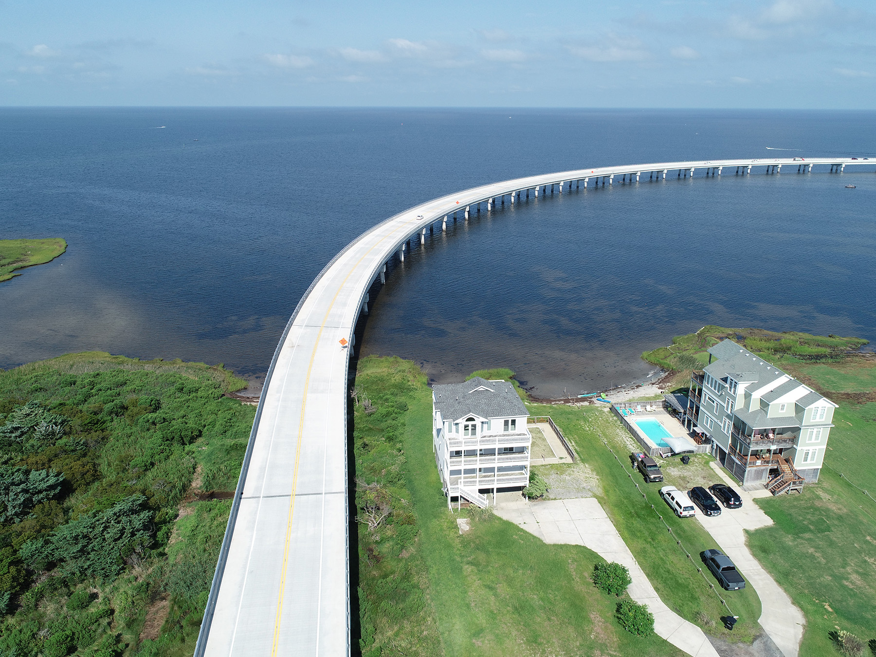 Uniquely shaped bridge curves over a large body of water. 