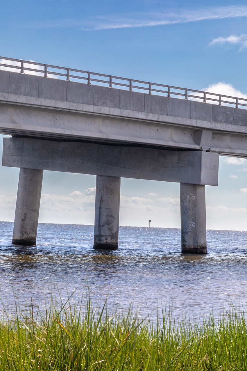 Image shows bridge piers in water. 