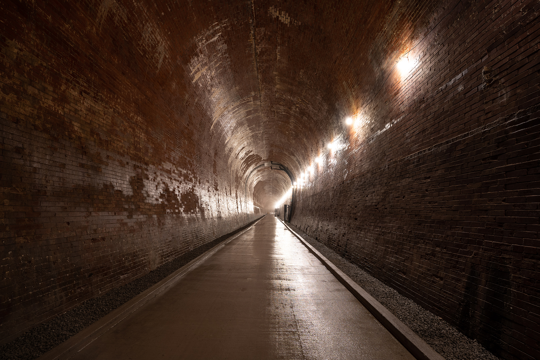 The tailrace tunnel, ready for visitors. Original tunnel construction teams took day and night shifts to assemble the structure, with evening employees fitting in arch keys as the construction progressed. (Image courtesy of Niagara Parks)