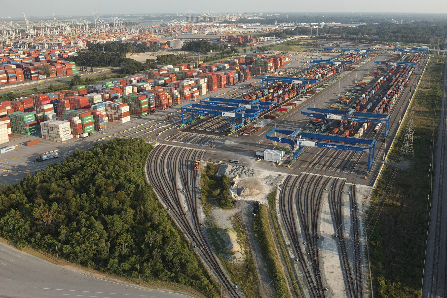 Photo shows a rail yard full of shipping containers.