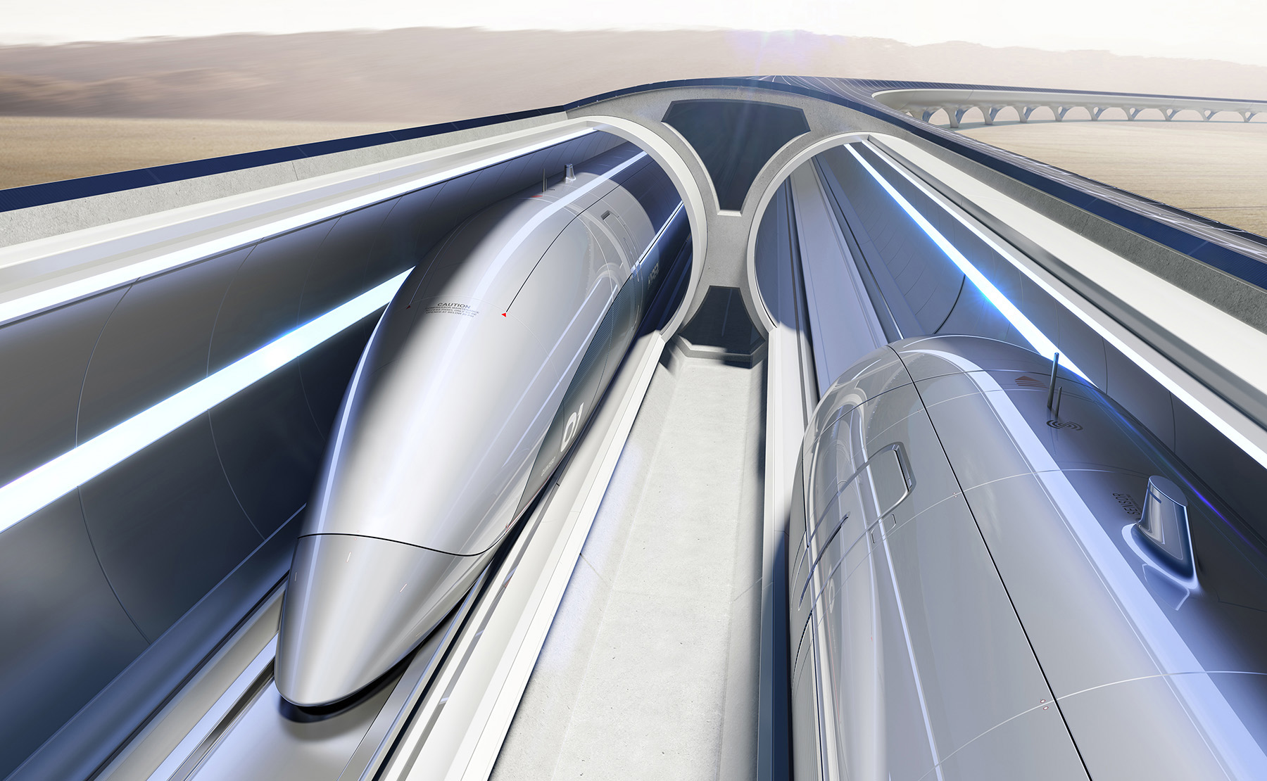 Futuristic steel train cars shaped like tubes on a track.