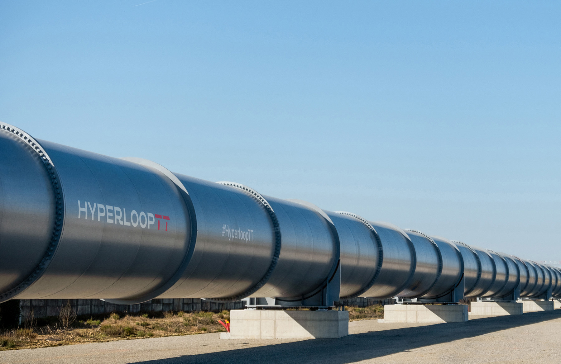 Steel semicircular tube with the word HyperloopTT on the side.