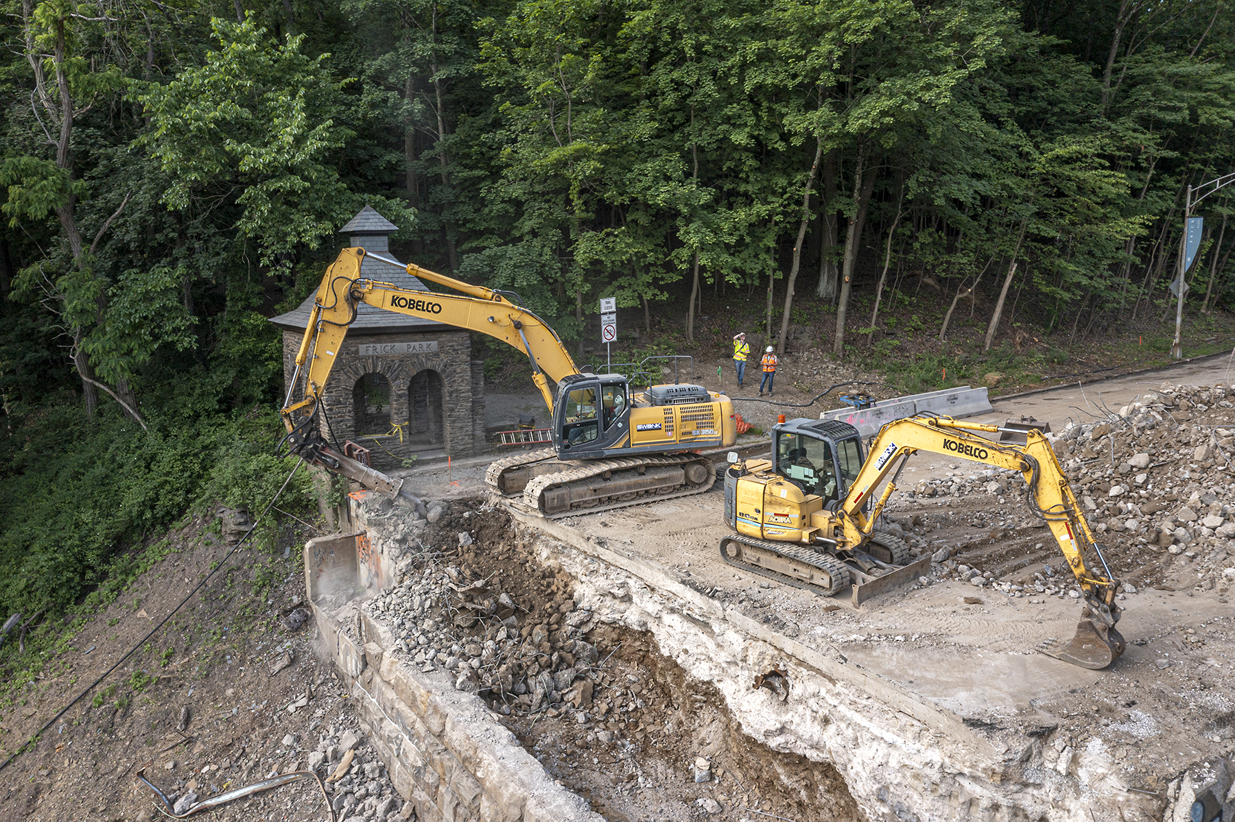 Construction crews conduct site preparation work on the west abutment near the historic Frick Park Gatehouse. (Image courtesy HDR Inc.)