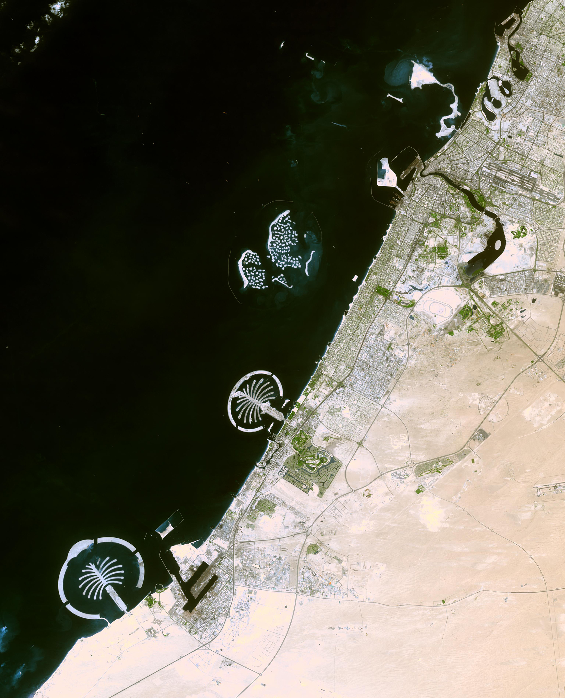 Creation of human-made islands like the Palm Islands along the coast of Dubai are driven by real estate markets. But land reclamation also occurs for industrial purposes like expanding ports or airports. All these projects require lots of sand to build and maintain the new land. (Image courtesy of NASA/GSFC/MITI/ERSDAC/JAROS, and U.S./Japan ASTER Science Team)