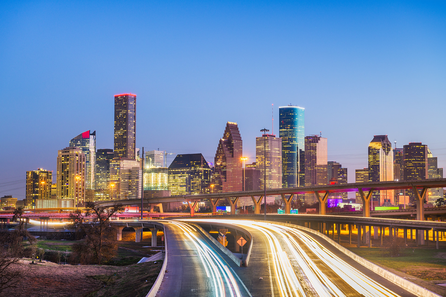 The Houston skyline showing buildings, highways, and road signs.