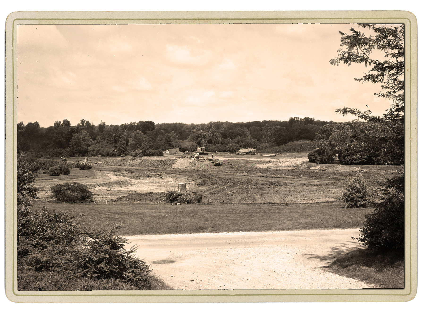 Historical photo shows work crews excavating a large plot of land.