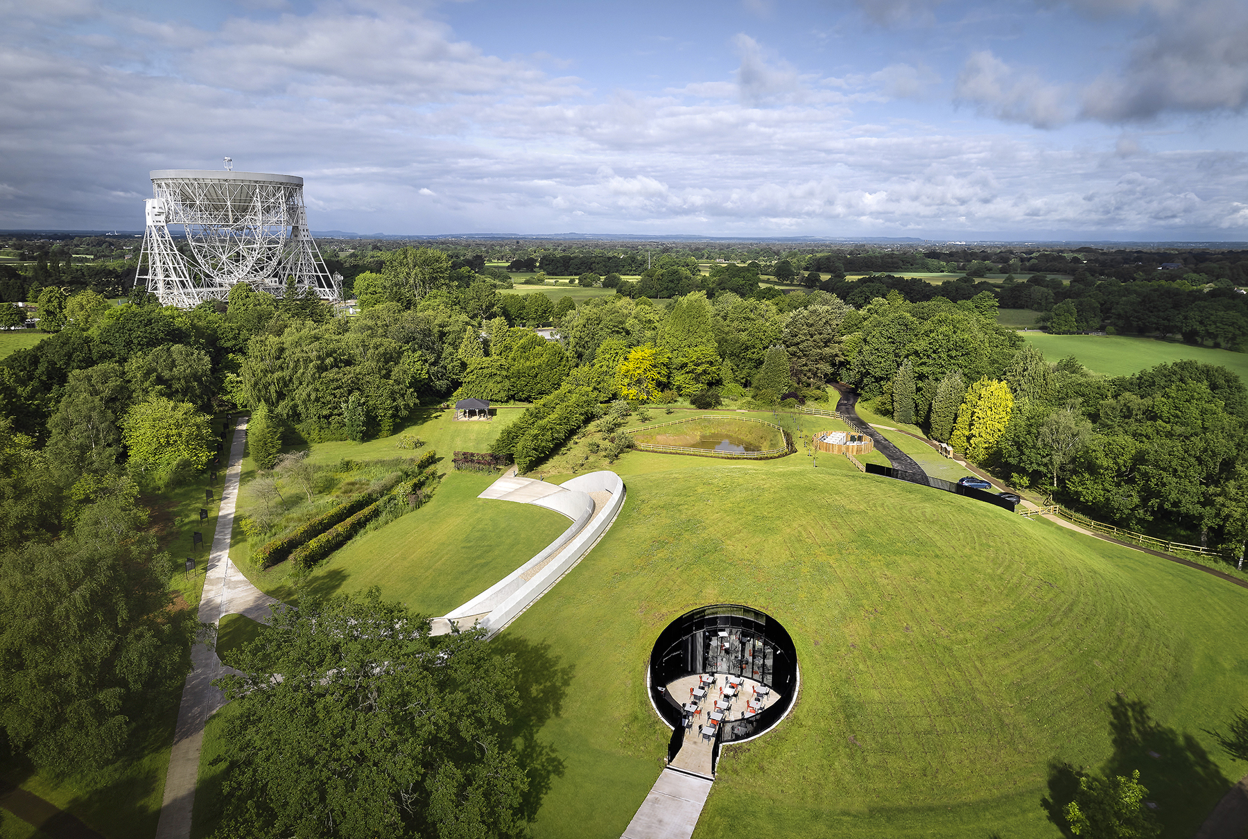 Opened in 2022, the First Light Pavilion at the Jodrell Bank Observatory near Manchester, England, comprises a large dome that emulates the nearby Lovell Telescope without interfering with its operation. (Image courtesy of Hufton + Crow)