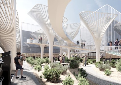 People walk through a large open space on paths and elevated walkways. There are tall, white multipronged structures sticking out of the ground.