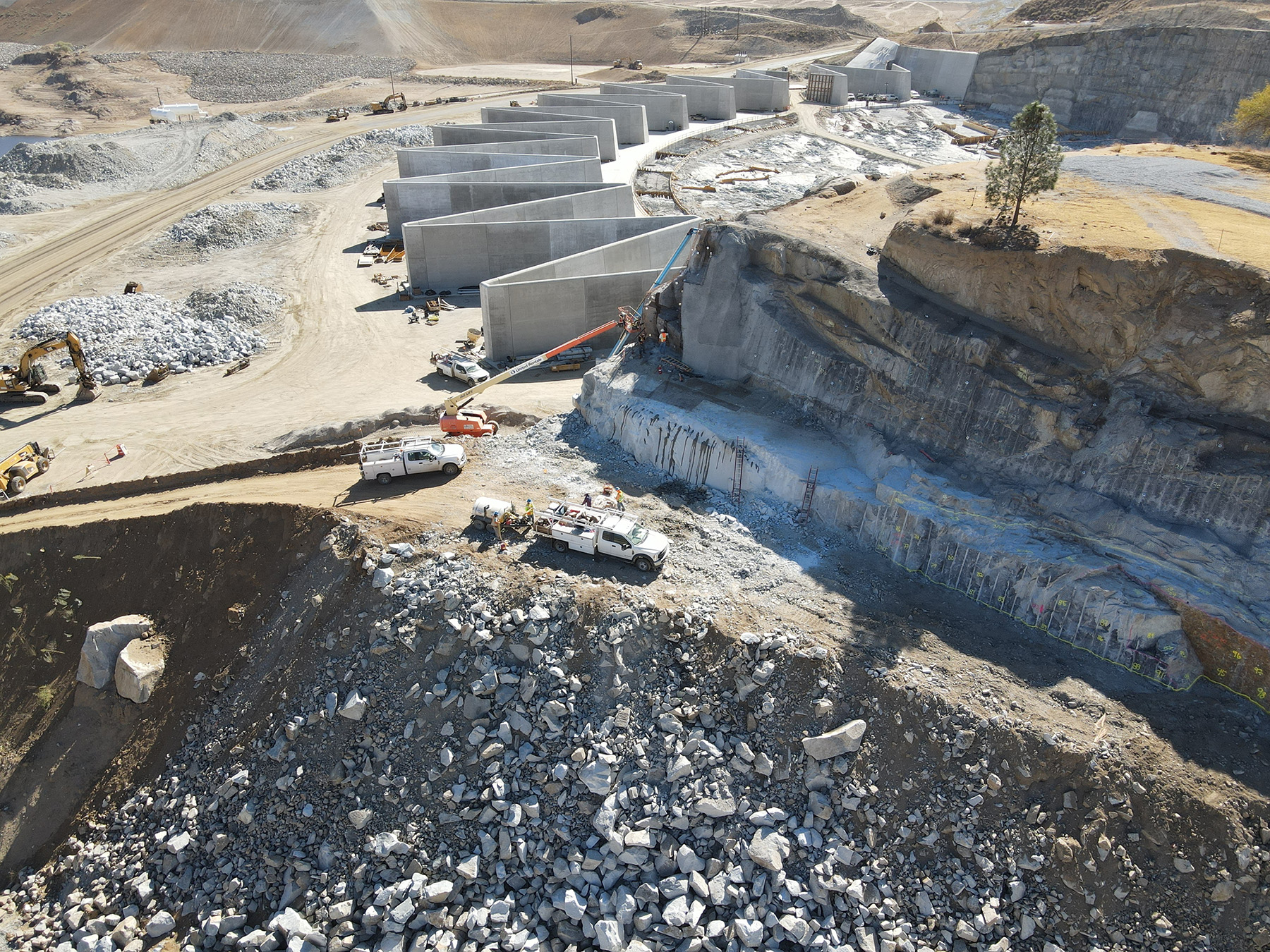 A protective netting has been installed on rocks between an emergency spillway being built and the existing spillway.