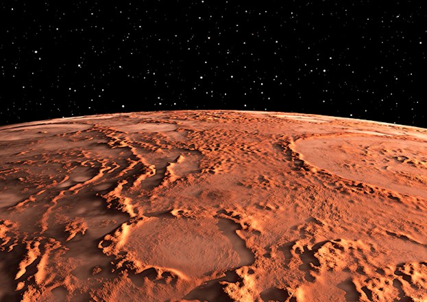 Photograph shows the surface of Mars with canyons, volcanos, and polar ice caps.