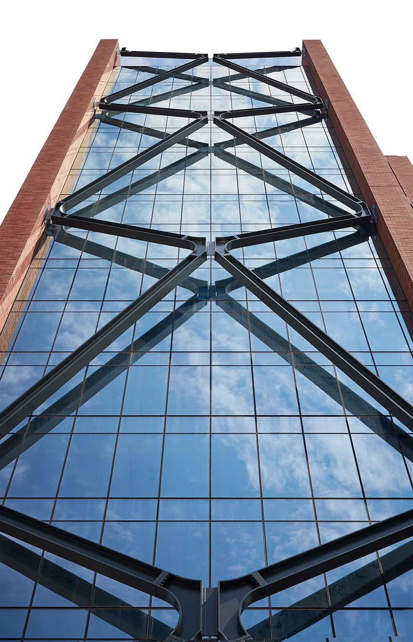 One side of a high-rise building is shown with its x-shaped steel braces. 