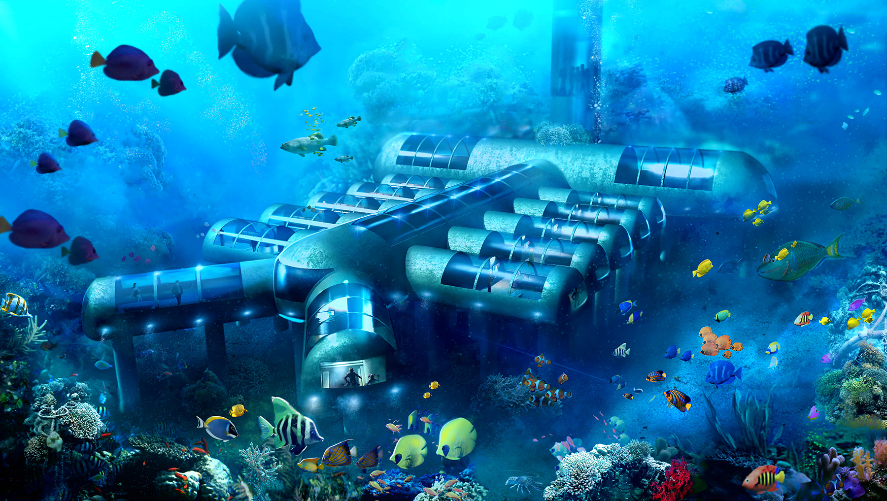 The rendering shows an underwater habitat made up of multiple cylinders attached to a long cylinder. Fish swim in the background. 
