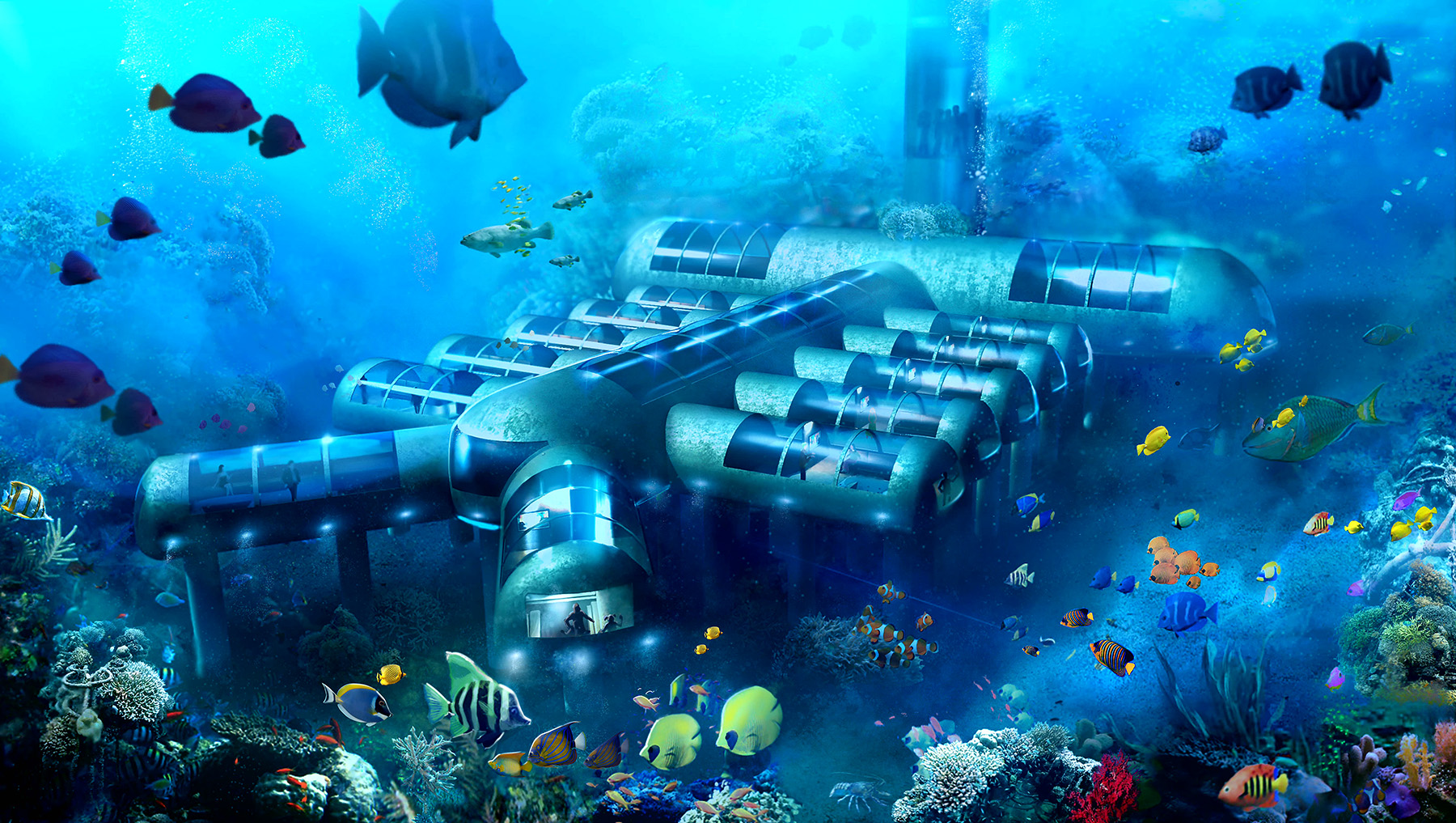 The rendering shows an underwater habitat made up of multiple cylinders attached to a long cylinder. Fish swim in the background.