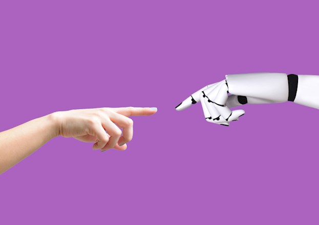 A human hand and a robotic hand are almost reach for each other.