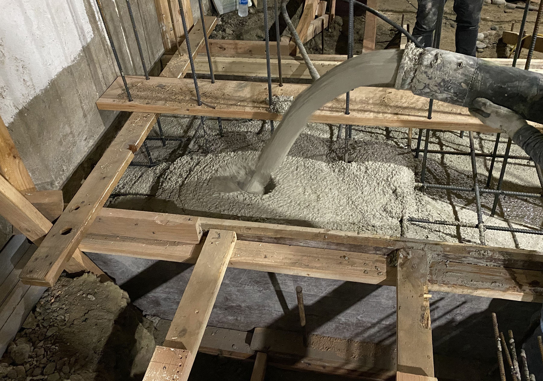 C-Crete, a portland-cement-free concrete that is workable and has great flowability for construction projects, is being placed in a building foundation in Seattle. (Image courtesy of R. Savary, C-Crete Technologies)