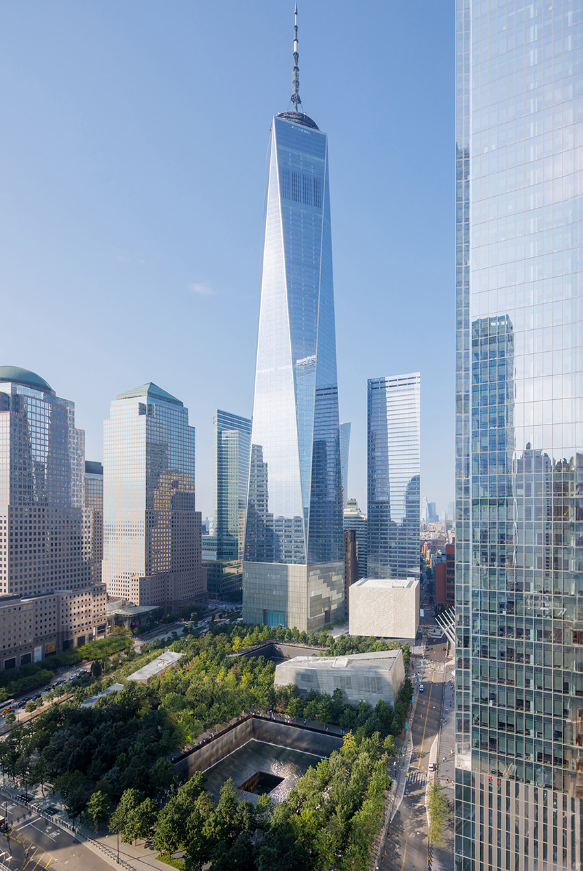 A short, square building next to high rises in downtown New York City.