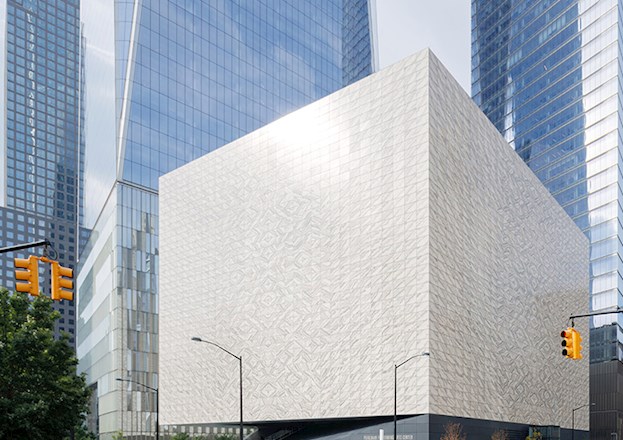 Street view of a light-colored, square building.