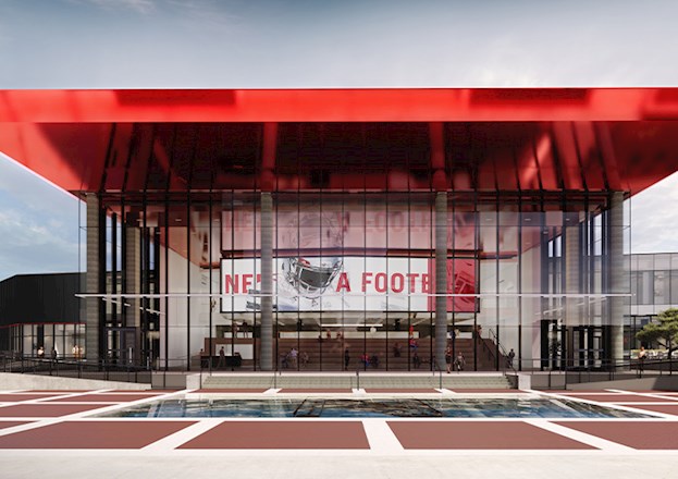 Rendering shows a double-height building with a large red canopy. 