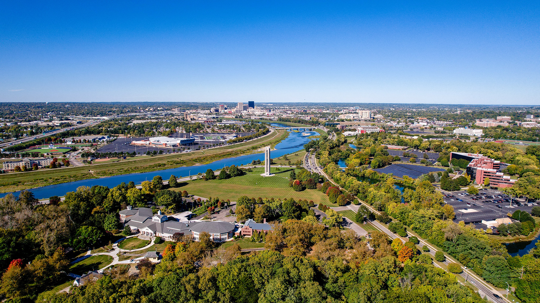 The photograph shows a river meandering through a city. 