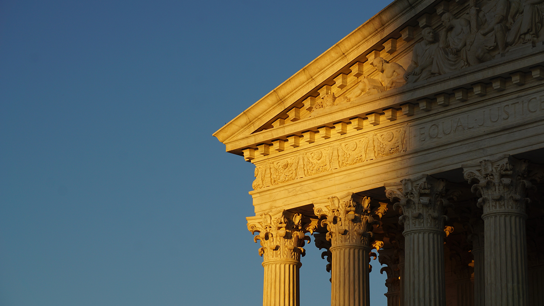 picture of judicial building with part of the image in shadow.