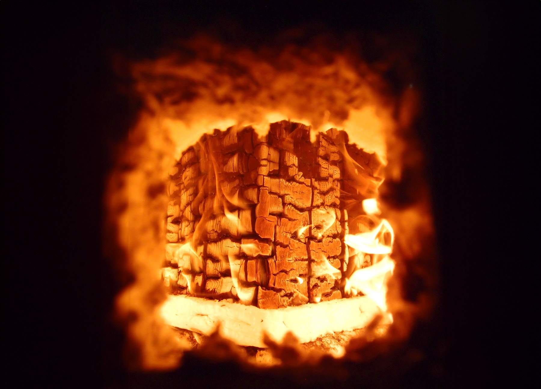A block of wood is on fire. 