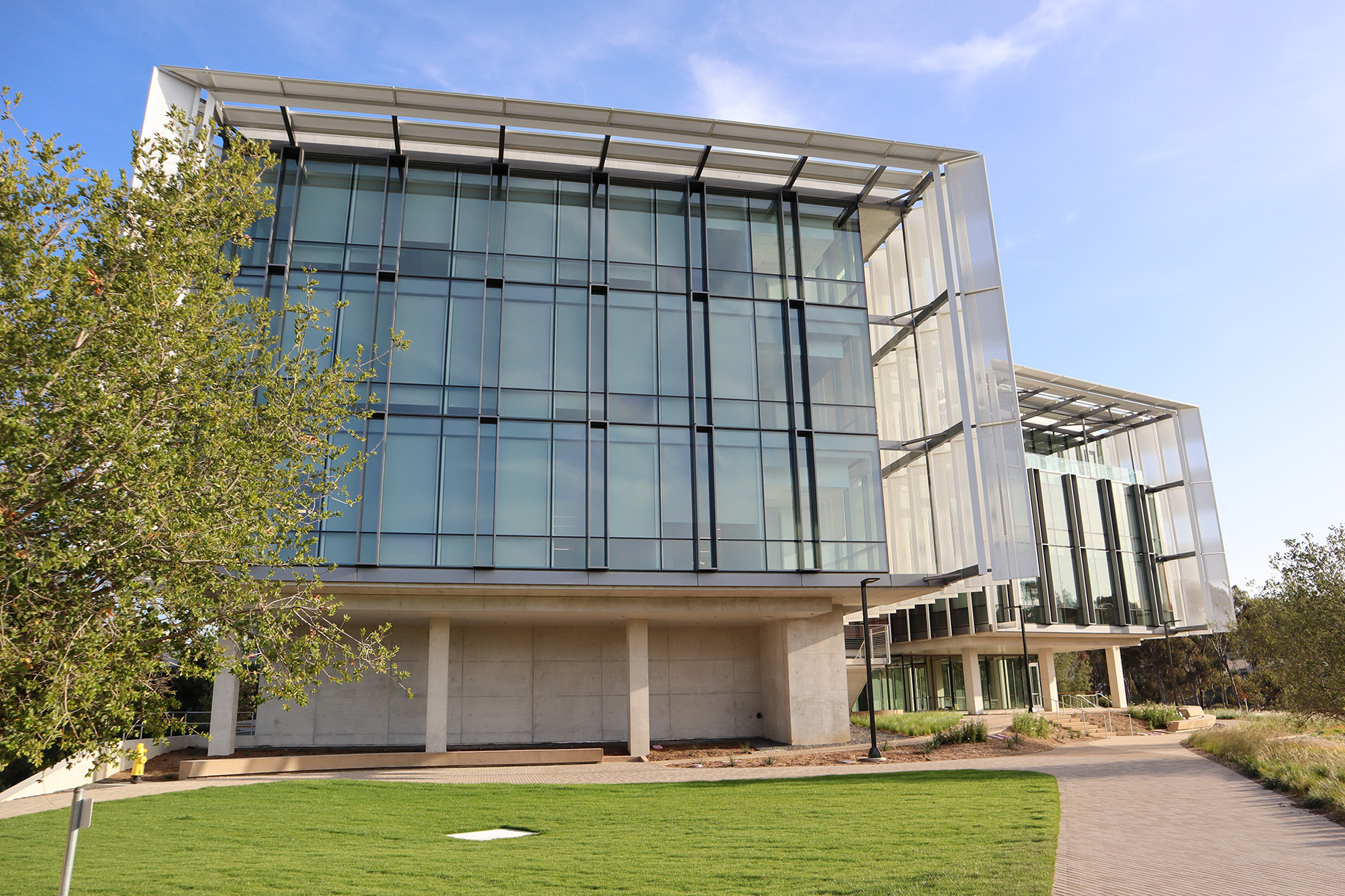 One side of a building with a full-height glass wall. 