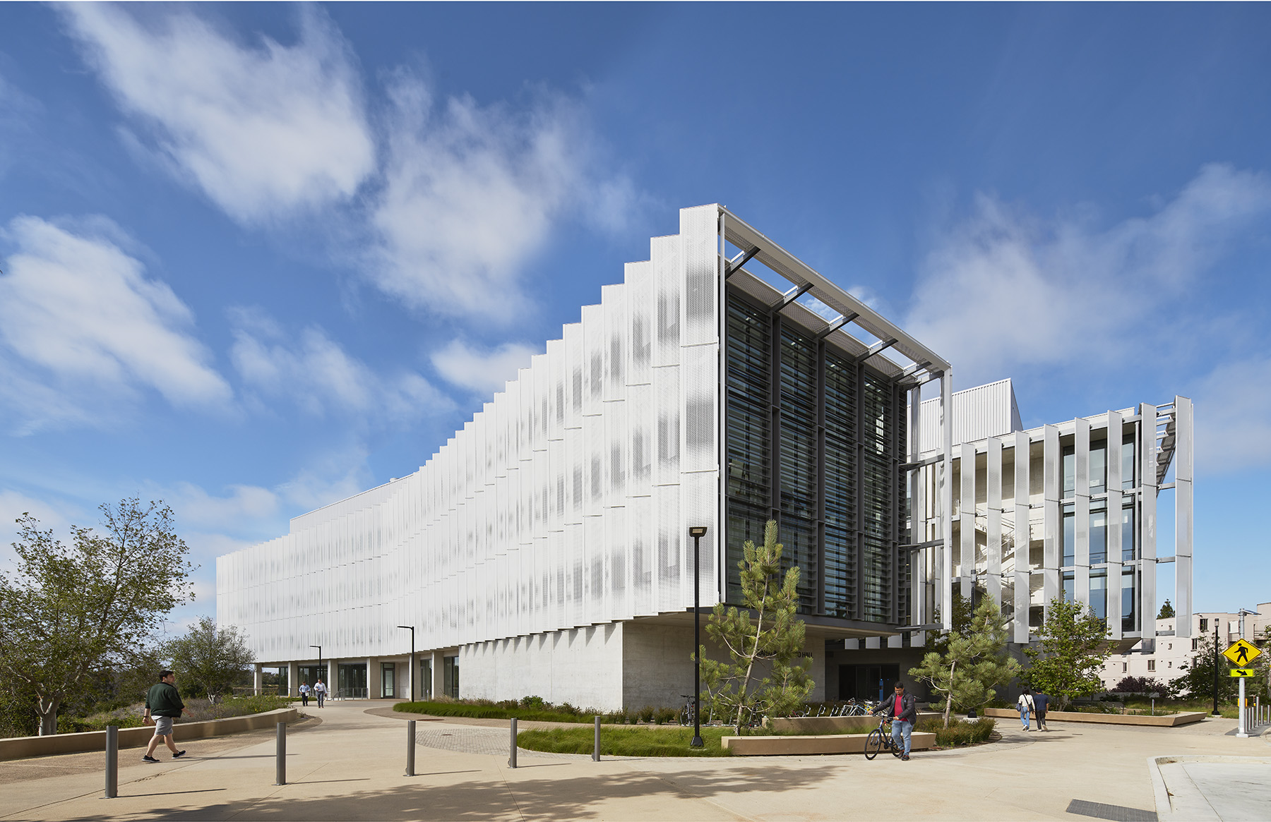 The outside finished version of Franklin Antonio Hall with grass, trees, and sidewalks. 