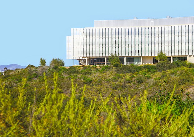 A large building sits on the San Diego hillside. 