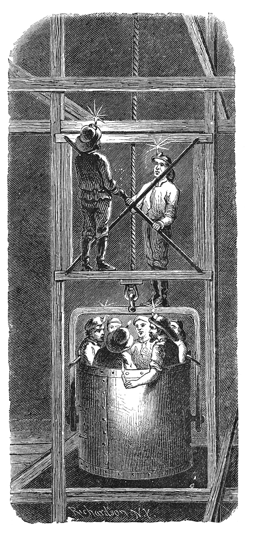 Men in a metal bucket descend through a shaft. 
