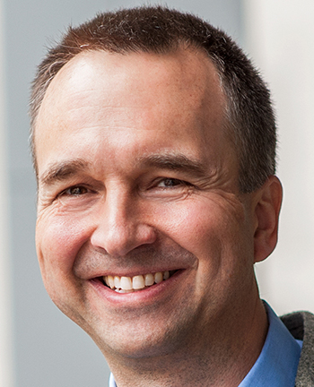 headshot of a smiling man