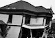 black and white photo of a collapsing house