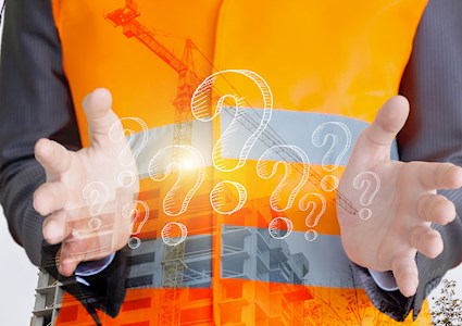 Image shows a man holding imaginary question marks between his hands.