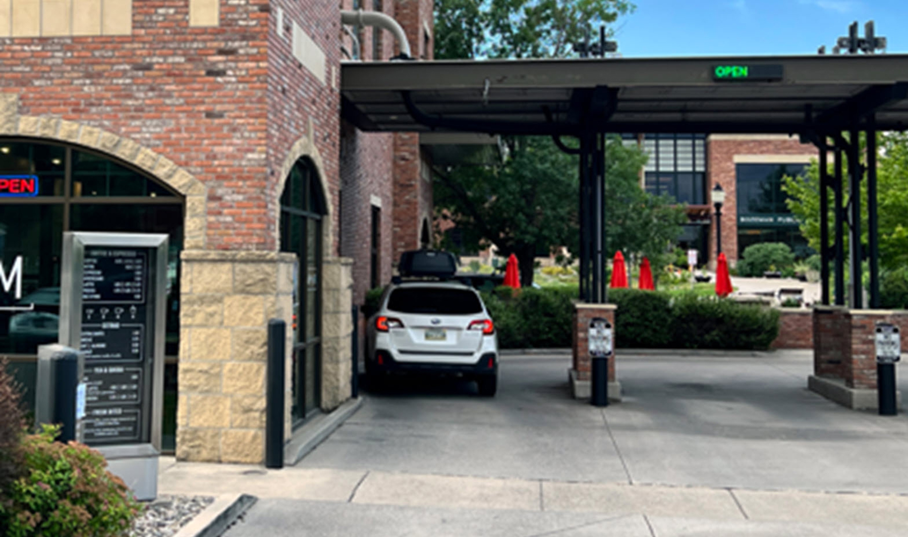 a car waits at a drive-thru window a car waits at a drive-thru window