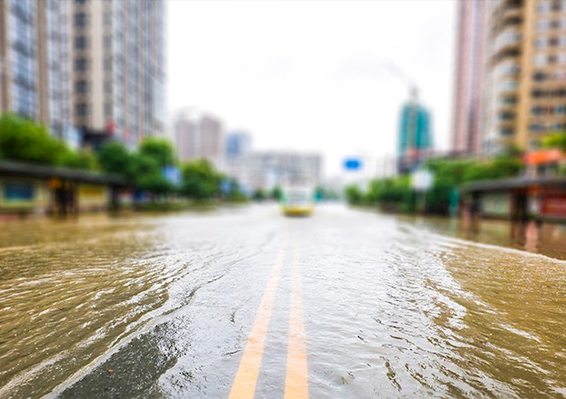 Photograph shows a flooded street.