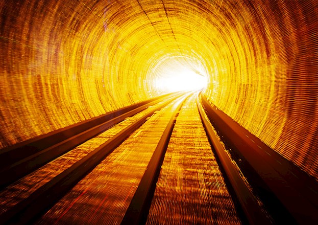 A rail tunnel is brightly lit.