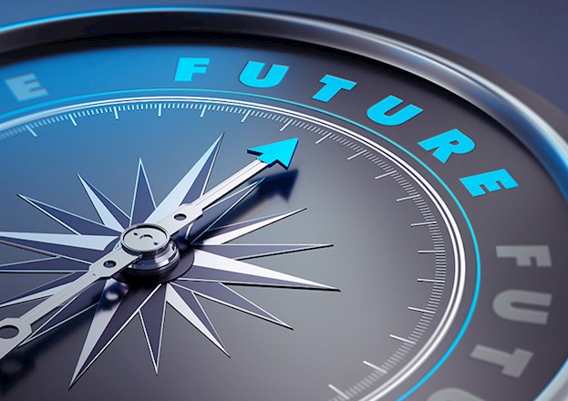 Photograph shows a compass needle pointing toward the word “future.”
