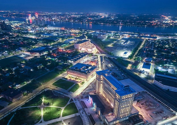 The towering former train station is shown at night, all lit up.