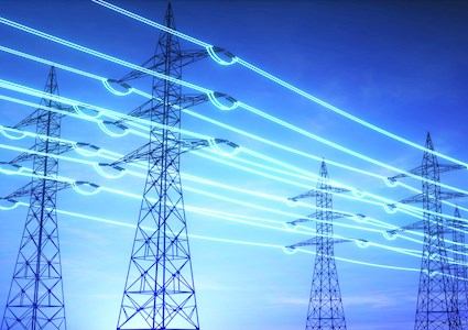 A network of power lines highlighted in blue stretch across an evening sky.