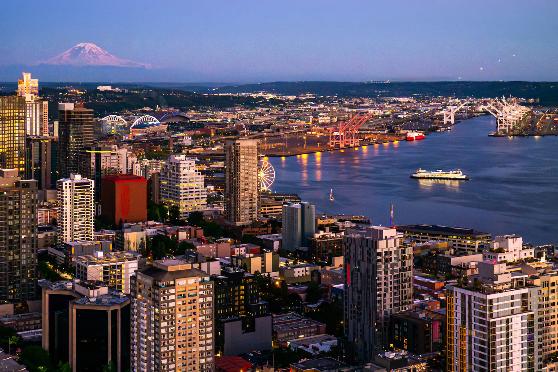 The city skyline and the waterfront are shown against a mountain backdrop. 