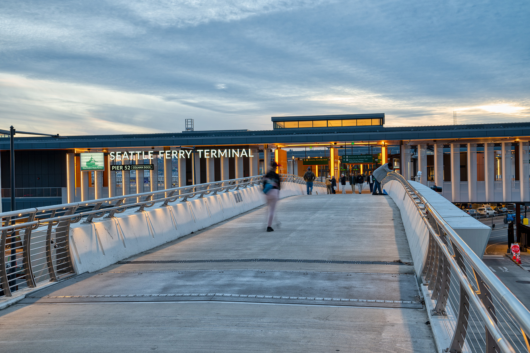 In this photo a bridge leads toward the columned ferry terminal building. 