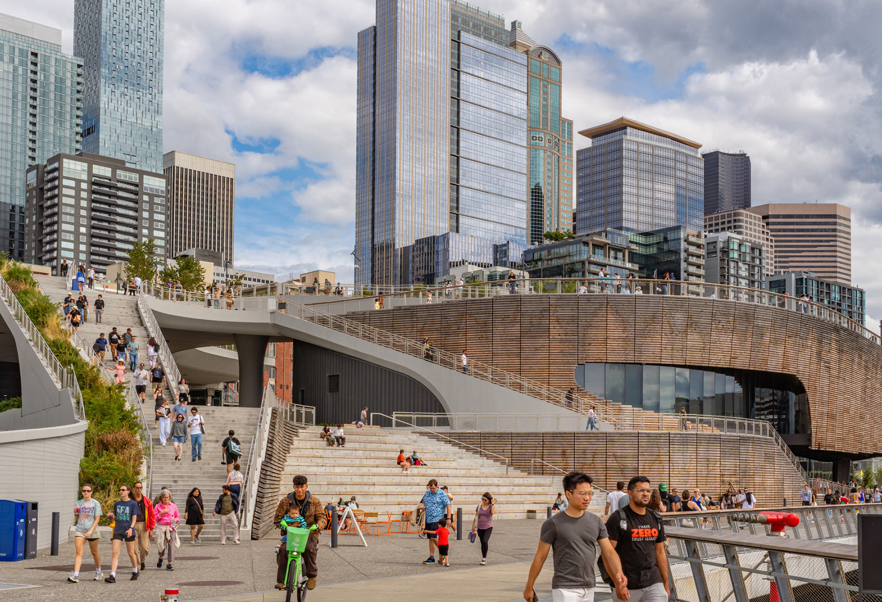 The photo depicts crowds moving down and across the concrete structures of the Overlook Walk. 