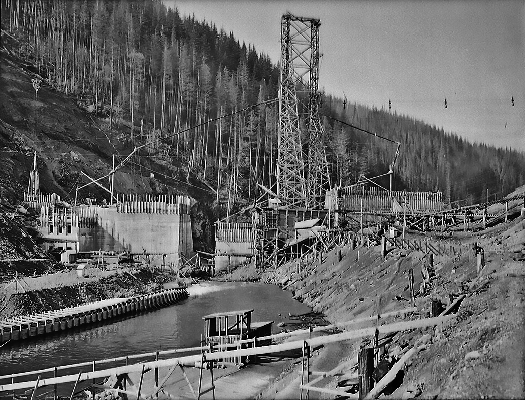 Image shows a concrete dam under construction. 