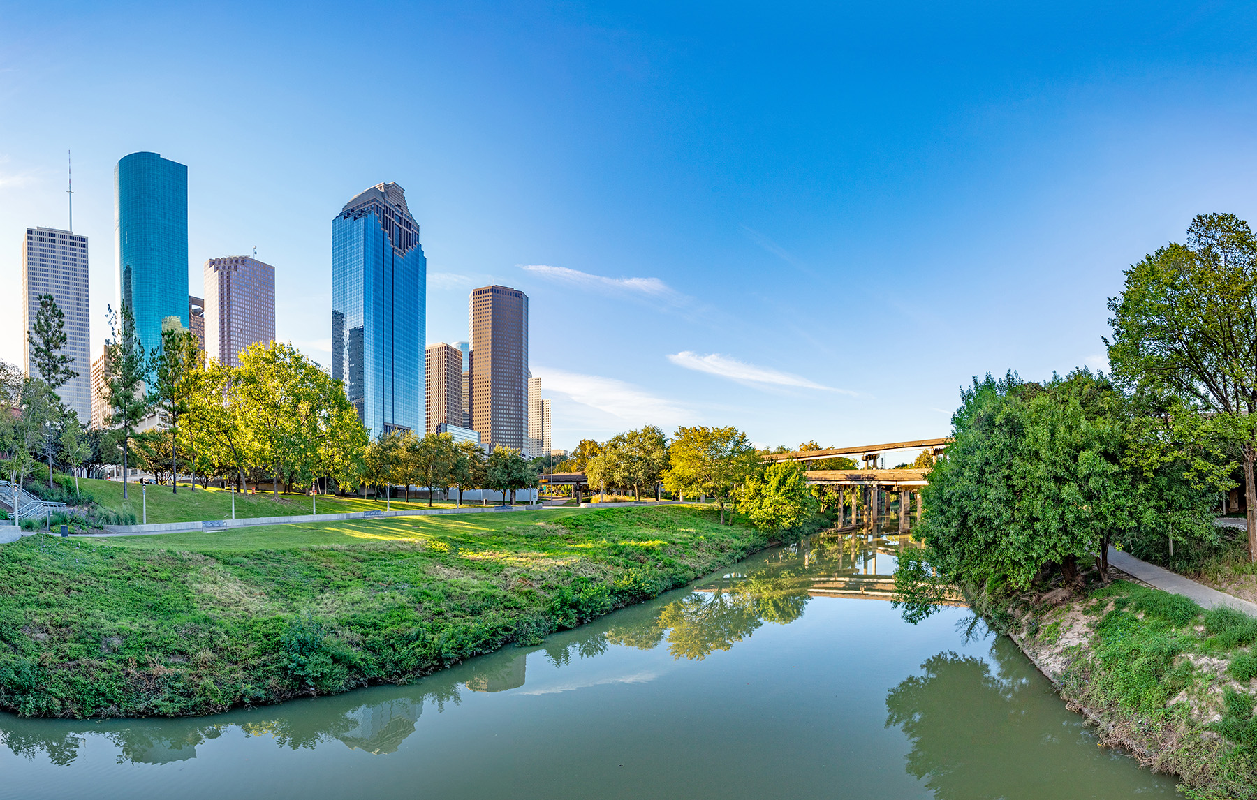 A river is shown on the lower half of the photo, with skyscrapers and bridges in the background. 